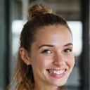 Smiling young woman, early 20s, with a vibrant, athletic appearance, radiating health.